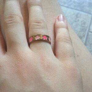 Faux gold rings, one with green hearts, and one with pink stars.
